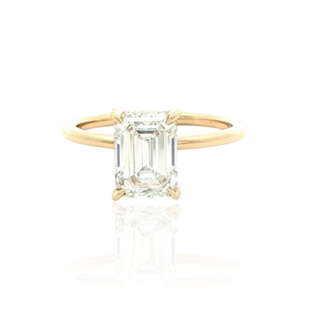 Selman's Jewelers 14k yellow gold engagement ring with a 2.13ct emerald cut lab grown diamond and hidden halo.