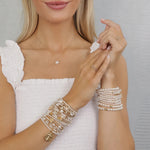 Selman's Jewelers gold filled bracelet stack with pearls and cross charms, and matching pearl necklace and rings.