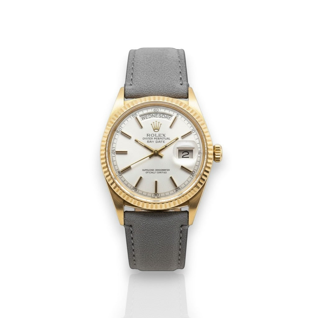 Selman's Jewelers 18k yellow gold Rolex Day-Date 36mm watch with white dial and fluted bezel. Features day and date complications.