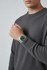 Selman's Jewelers Rolex Submariner 'Starbucks' watch with black dial, green ceramic bezel, and stainless steel bracelet.