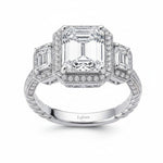 Selman's Jewelers three-stone emerald-cut diamond anniversary ring with pave halo and twisted band.