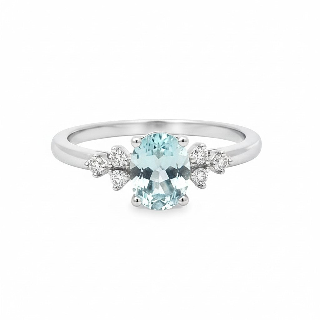 Selman's Jewelers 14k white gold ring with oval aquamarine and cluster diamond accents.