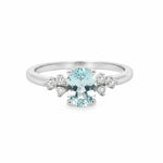 Selman's Jewelers 14k white gold ring with oval aquamarine and cluster diamond accents.